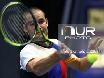 Mikhail Youzhny of Russia returns the ball to Fabio Fognini of Italy during the St. Petersburg Open ATP tennis tournament match in St. Peter...