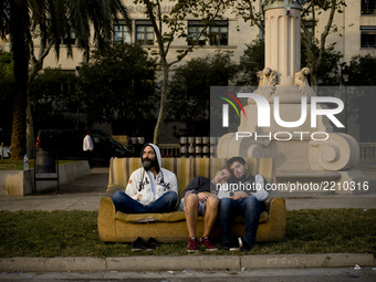 Pro-independence  supporters rest in a sofa after having spend the night in front of  the Catalan High Court building in Barcelona, Spain, o...