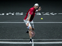 Team World player John Isner of United States returns the ball to Team Europe player Dominic Thiem of Austria during the first day at Laver...
