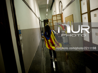 A student carriyng a estelada flag (sign of Catalonia independence) goes by a corridor at the  University of Barcelona, Spain, on 22 Septemb...