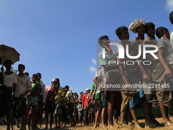 Rohingya Muslims gather for relief materials at a refugee camp in Teknaf, Bangladesh on September 22, 2017.  More than 400,000 Rohingya Musl...