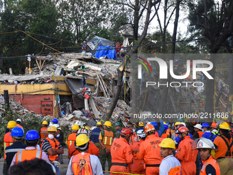 Rescuers are seen during their rescue efforts in the rubble of the multi-family apartments on  Tlalpan Avenida due to the earthquake that st...