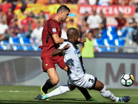 Edin Dzeko of Roma is challenged by Samir of Udinese during the Serie A match between Roma and Udinese at Olympic Stadium, Roma, Italy on 23...