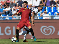 Diego Perotti of Roma is challenged by Valon Behrami of Udinese during the Serie A match between Roma and Udinese at Olympic Stadium, Roma,...