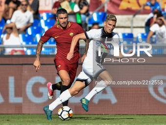 Aleksandar Kolarov of Roma is challenged by Jens Stryger Larsen of Udinese during the Serie A match between Roma and Udinese at Olympic Stad...