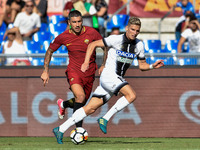 Aleksandar Kolarov of Roma is challenged by Jens Stryger Larsen of Udinese during the Serie A match between Roma and Udinese at Olympic Stad...