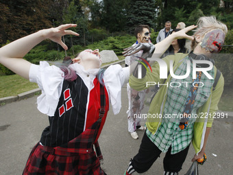 Ukrainians dressed up as zombies take part in a 