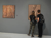 Visitors look at paintings by Ukrainian surrealist artist Ivan Marchuk at an exhibition in Ankara, Turkey on September 23, 2017. The exhibit...