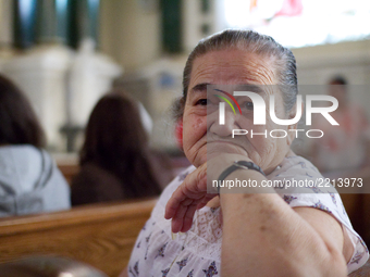 Maria Rodiguez attends a special mass a special mass for people of Mexico and Puerto Rico at Saint Patrick Church in Norristown, PA, on Sept...