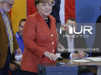 Prime minister Angela Merkel places a vote in general election for German Bundestag  on September 24, 2014, Berlin. She attended with her hu...