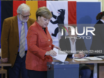Prime minister Angela Merkel places a vote in general election for German Bundestag  on September 24, 2014, Berlin. She attended with her hu...