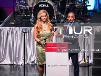 (L-R), TV personality Gizelle Bryant, and actor Hill Harper, speak at the Southern Company hosted 