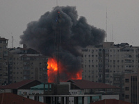 An explosion and smoke after an Israeli air strike on Al Zafir tower in Gaza City, 23 August 2014. (