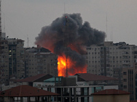 An explosion and smoke after an Israeli air strike on Al Zafir tower in Gaza City, 23 August  2014. (