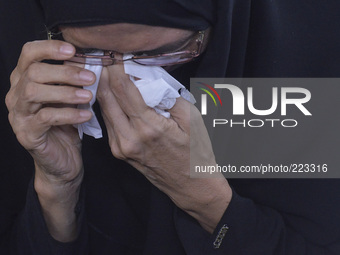  Widow of late Mohd Ghafar Abu Bakar,Normi Abdullah crying during funeral ceremony at Ampang,suburb of Kuala Lumpur on August 24,2014. (