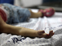 The body of a baby girl is brought to the Shifa hospital following Israeli Strikes hit Gaza City. Israel launched more air strikes on Gaza o...