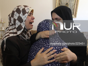 The mother (C) of Palestinian Boy  Mohammed Al KHodary 17 years, who medics said was killed by an Israeli air strike, is comforted as she mo...