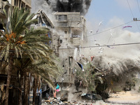 Smoke rises after Israeli aircraft hit a house in the Al-Shatea refugee camp in   Gaza City, 24 August 2014. (