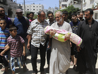Palestinian mourners carry the body of Zena Abu Taqiya, two years, during her funeral in Gaza City, 24 August 2014. who was killed in an Isr...