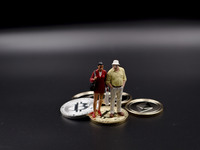 Miniature figures near Bitcoin physical token. (