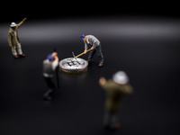 A view of Bitcoin token and a miner miniature figures.  (