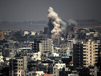 Smoke and sand are seen following what witnesses said was an Israeli air strike in Gaza August 25, 2014. Israeli air strikes killed at least...