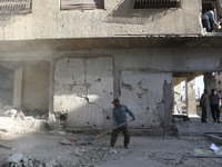 People remove rubble at thier destroyed house after airstrikes on rebel. held  Douma Outskirts of Damascus, Syria, 7 October 2017. At least...