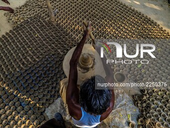 An Indian potter makes earthen lamps and other items ahead of Diwali festival in Jaipur,Rajasthan , India, 08 Oct,2017. People buy earthen l...