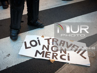 Legs of a riot policeman near a placard reading 'Law on work ? No thanks !'. More than 15000 protesters took to the streets of Toulouse agai...