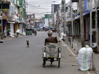 An elderly handicapped man rides his wheelchair on a deserted street in Jaffna city in the Norther province of Sri Lanka on 13 Friday Octobe...
