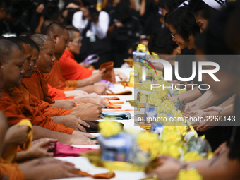 Thai Buddhist devotees give alms to a Buddhist monk at Siriraj Hospital in Bangkok, Thailand, 13 October 2017. King Bhumibol Adulyadej passe...