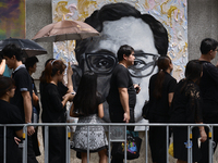 Thai Mourners in front of a portrait of late Thai king Bhumibol Adulyadej near the royal Grand Palace in Bangkok on October 13, 2017. King B...