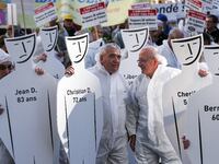 Protestors from the National Association for the Defense of Victims of Asbestos (ANDEVA) and from others associations carry carboard people...