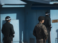 South Korean soldiers stand guard in the border village of Panmunjom between South and North Korea at the Demilitarized Zone (DMZ) on Octobe...