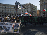 People hold a banner with a sign reading 'National Movement for Sovereignty' during a march in downtown Rome, on October 14, 2017.
About tw...