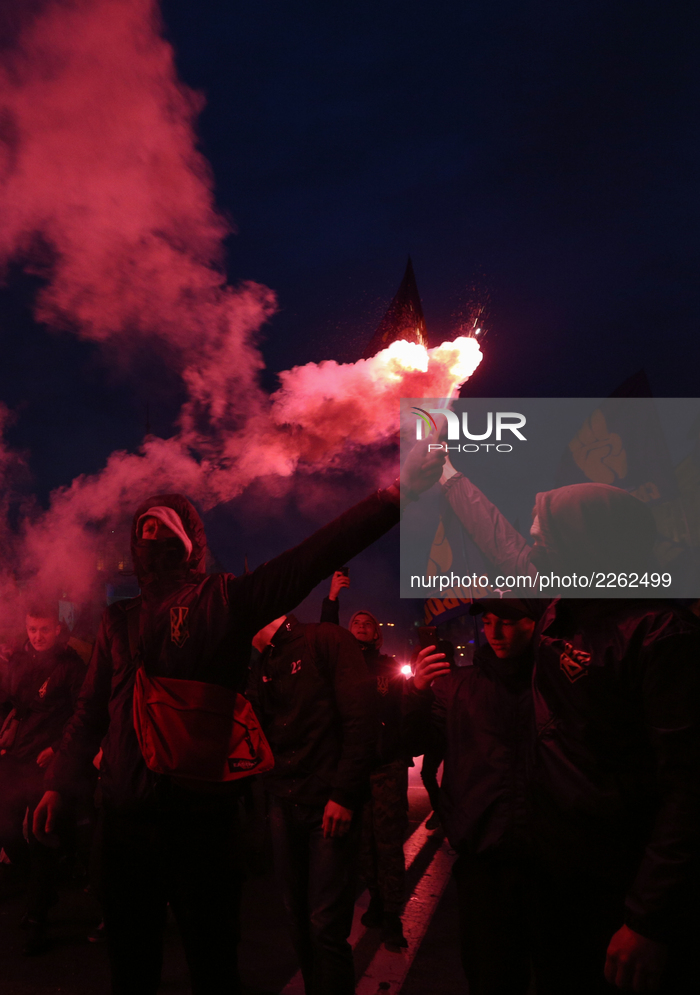 Activists and supporters of Ukrainian far right nationalist parties burn flares, torches and smoke grenades during their march to mark the 7...
