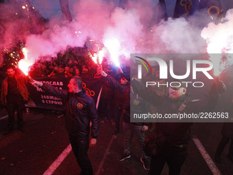Ukrainian far-right activists from different nationalist parties hold torches during a 
