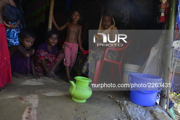 A Rohingya family member sits in makeshift house at the Balukhali makeshift Camp in Cox's Bazar, Bangladesh, on October 7, 2017. According t...