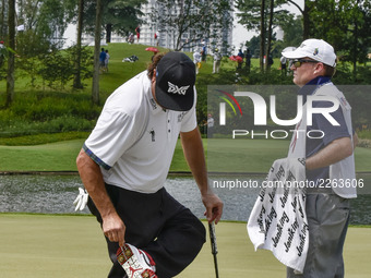 Pat Perez of USA picks off mud on his shoes during the CIMB Classic 2017 day 4 on October 15; 2017 at TPC Kuala Lumpur, Malaysia. (