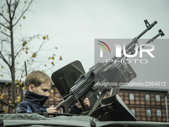 A young girl is seen in the gun turret of an armored personnel carrier on NATO day in Bydgoszcz, Poland on October 14, 2017. (