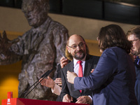 Chairman of the German Social Democratic Party (SPD) Martin Schulz (C) speaks after the announcement of a first projection of the election r...