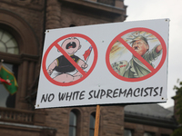 Protestor holds a sign condemning American President Donald Trump during a rally against White Supremacy and Islamophobia at Queen's Park in...
