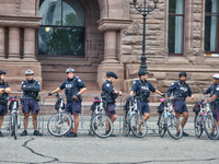 Police officers stand guard during a rally against White Supremacy and Islamophobia at Queen's Park in Toronto, Ontario, Canada, on October...
