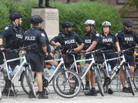 Police officers stand guard during a rally against White Supremacy and Islamophobia at Queen's Park in Toronto, Ontario, Canada, on October...