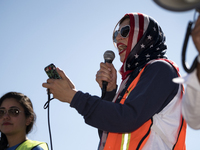 Mirvette Judeh, with the Arab American Civic Council, speaks during a protest against President Trump's travel ban, dubbed by activists as M...