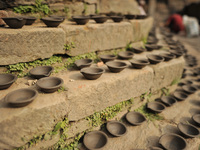 Nepalese people arranged clay pot lamps, being sun dried for upcoming Tihar or Deepawali Festival on his workshop at Pottery Square, Bhaktap...