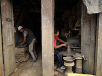 A Nepalese artist making clay pot lamps for upcoming Tihar or Deepawali Festival on his workshop at Pottery Square, Bhaktapur, Nepal on Mond...