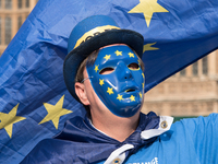 An anti-Brexit demonstration with masks and flags takes place outside the Houses of Parliament in London on October 16, 2017. Prime Minister...