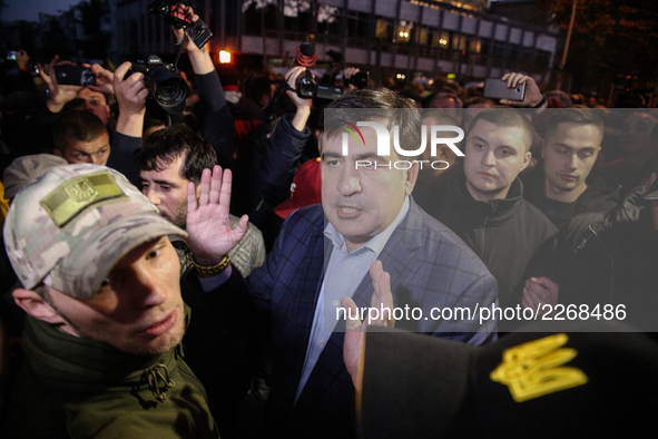 Mikheil Saakashvili, surrounded with his guards, walks through the crowd of his supporters. Protesters, who participat large-scale rally in...