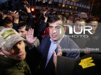 Mikheil Saakashvili, surrounded with his guards, walks through the crowd of his supporters. Protesters, who participat large-scale rally in...